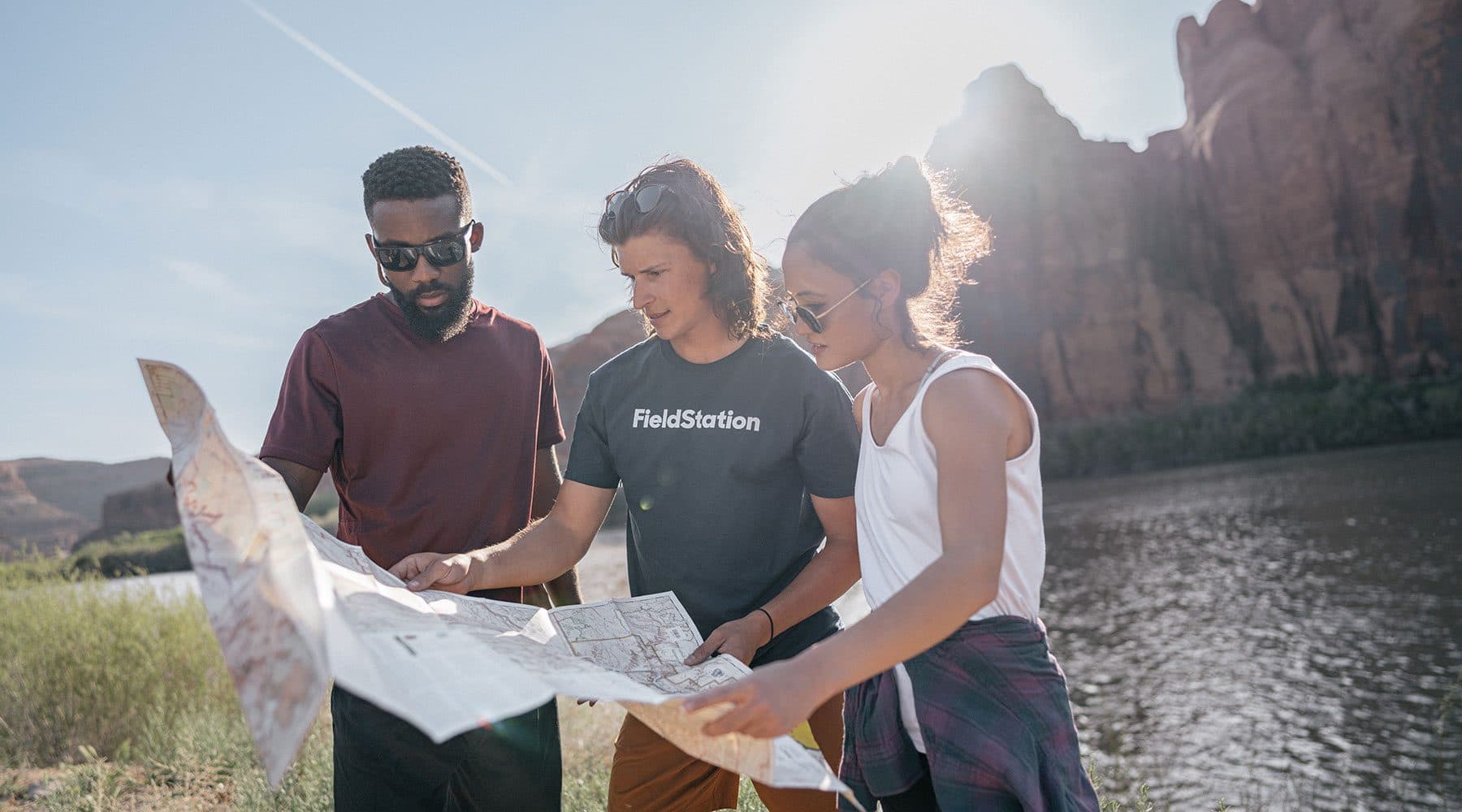 three people looking at a map
