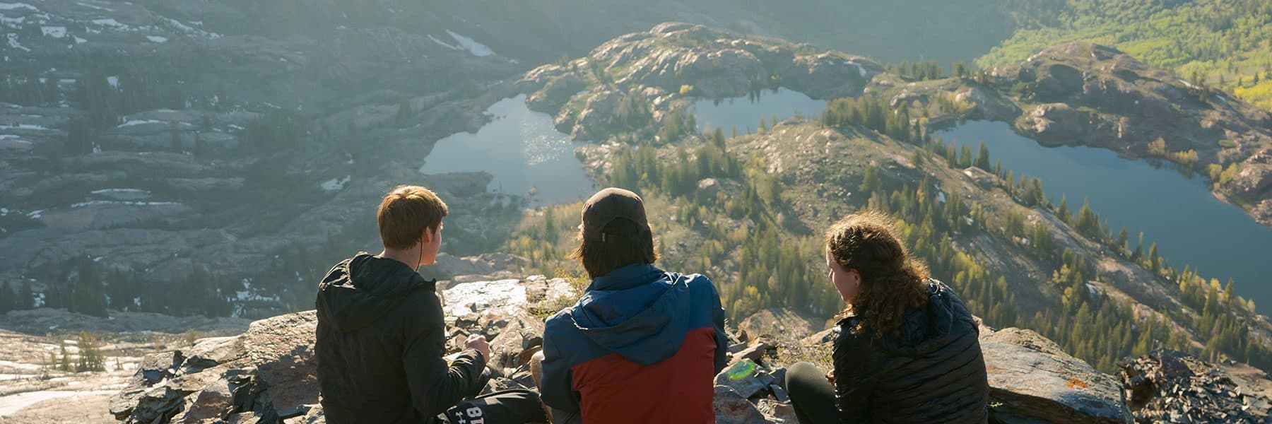 three people sitting looking down at the view