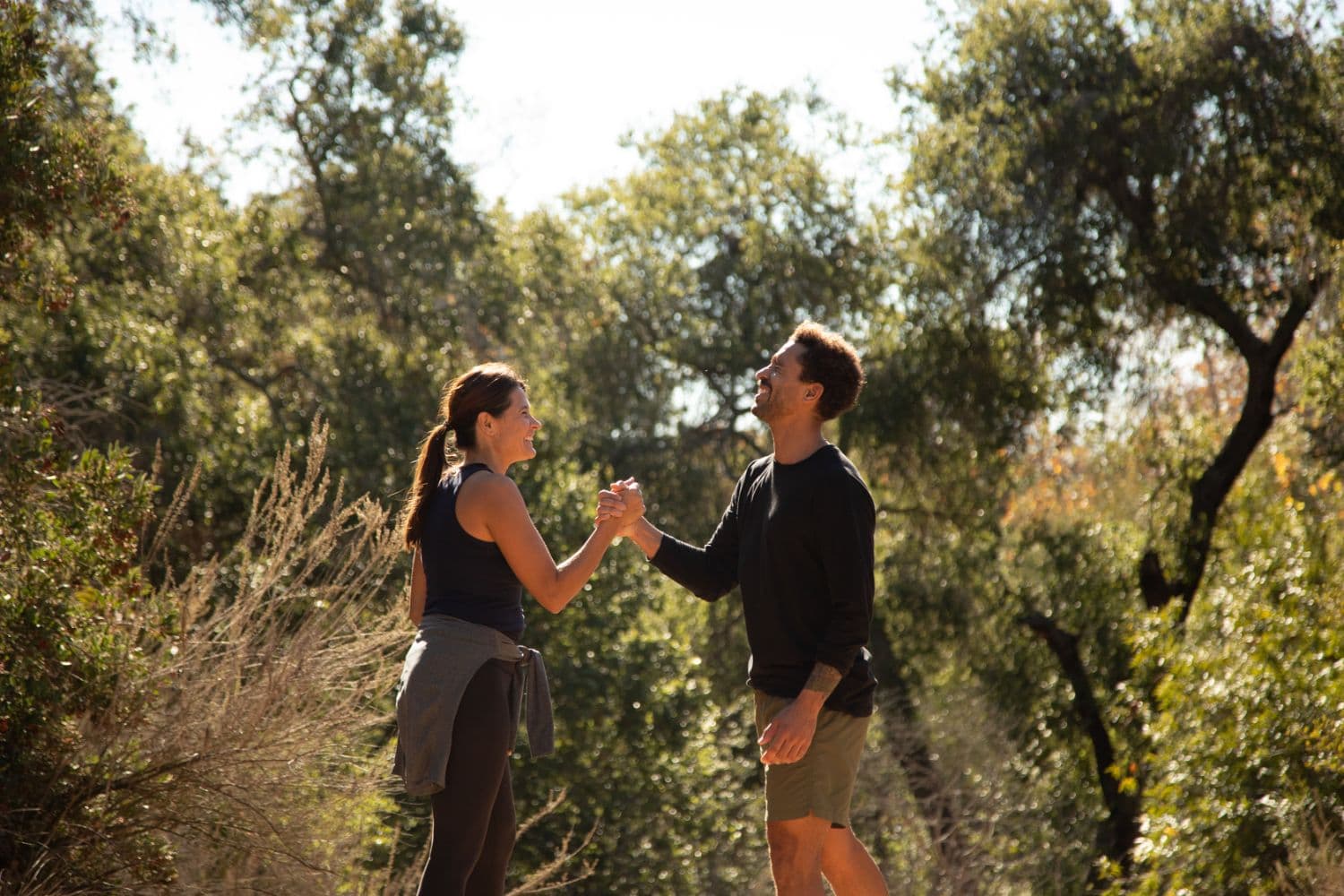 two people shaking hands outside