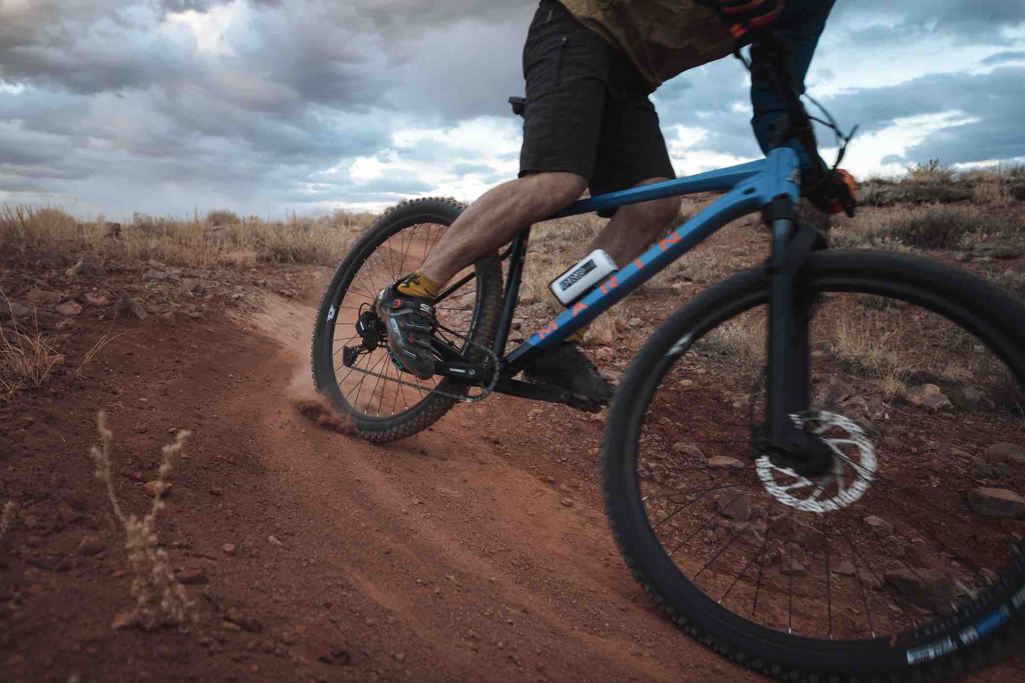 A man biking down a dirt path