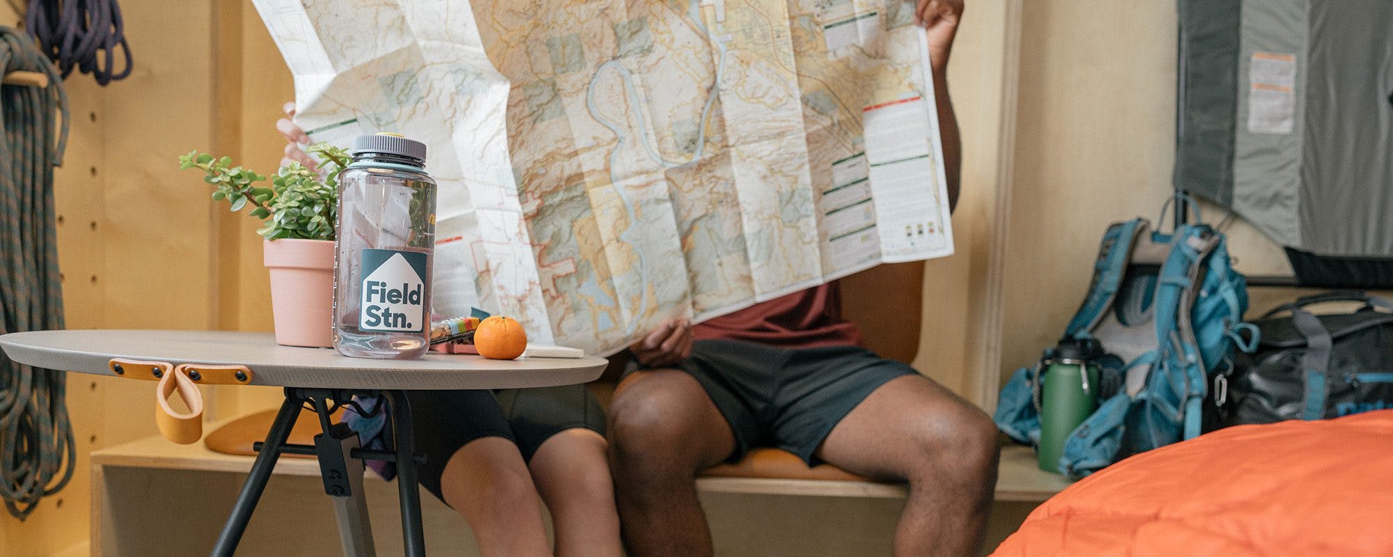 two people sitting looking at a paper map