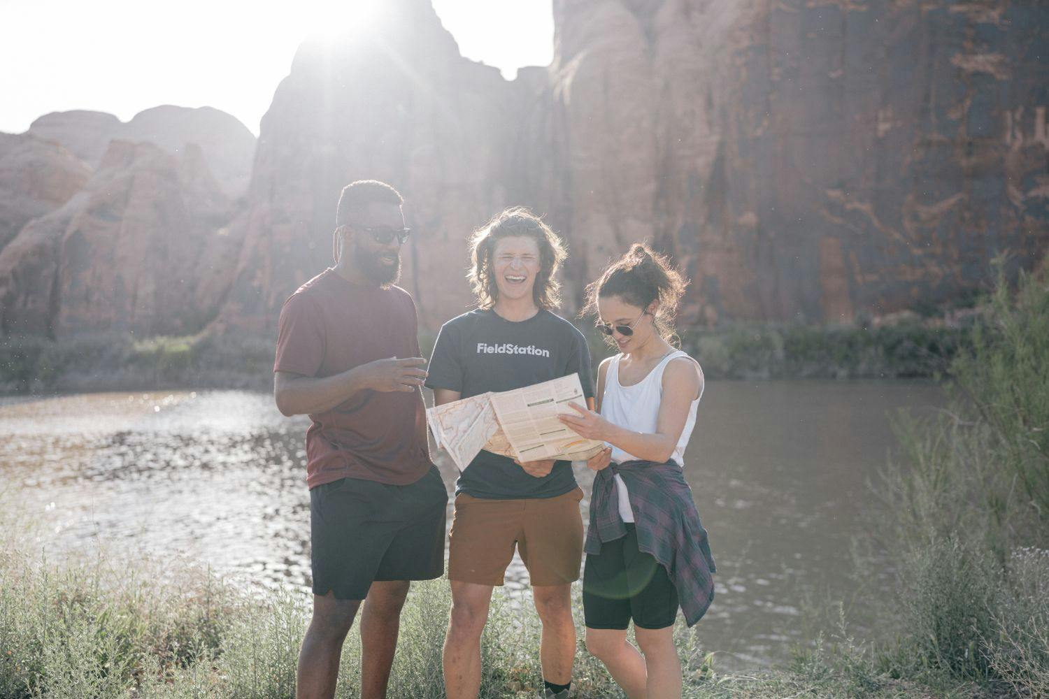 three people looking at a map