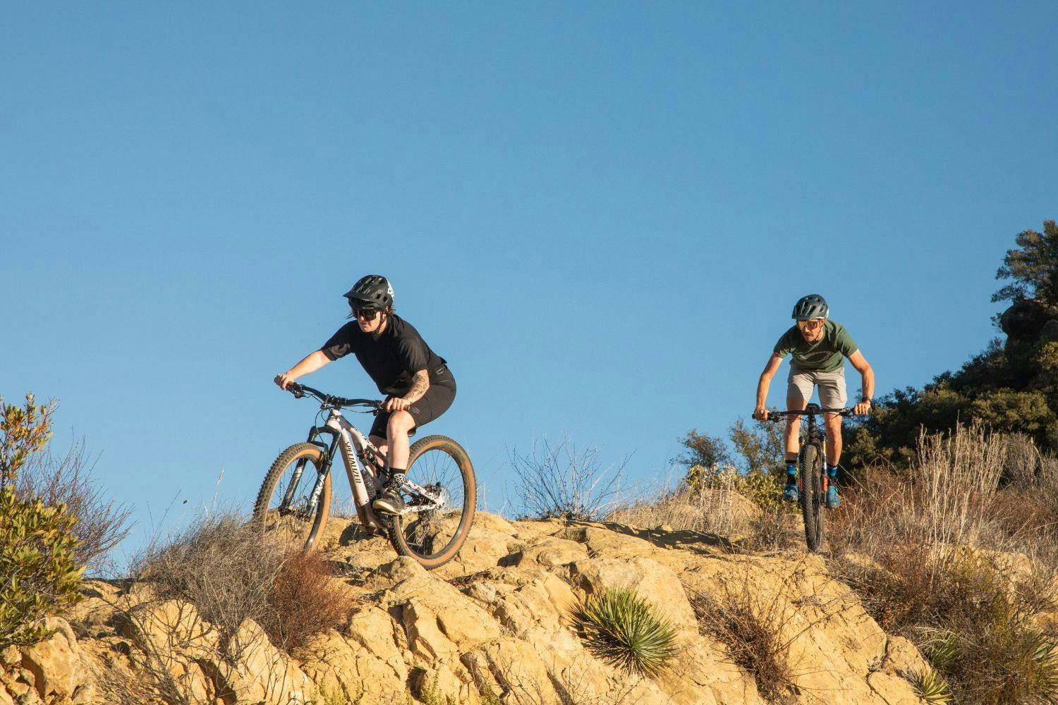two people riding their bicycles on a canyon
