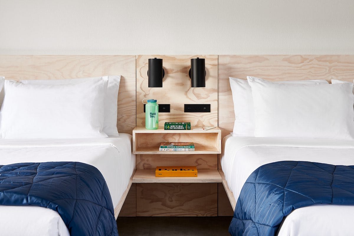 Two double beds with a side table in between