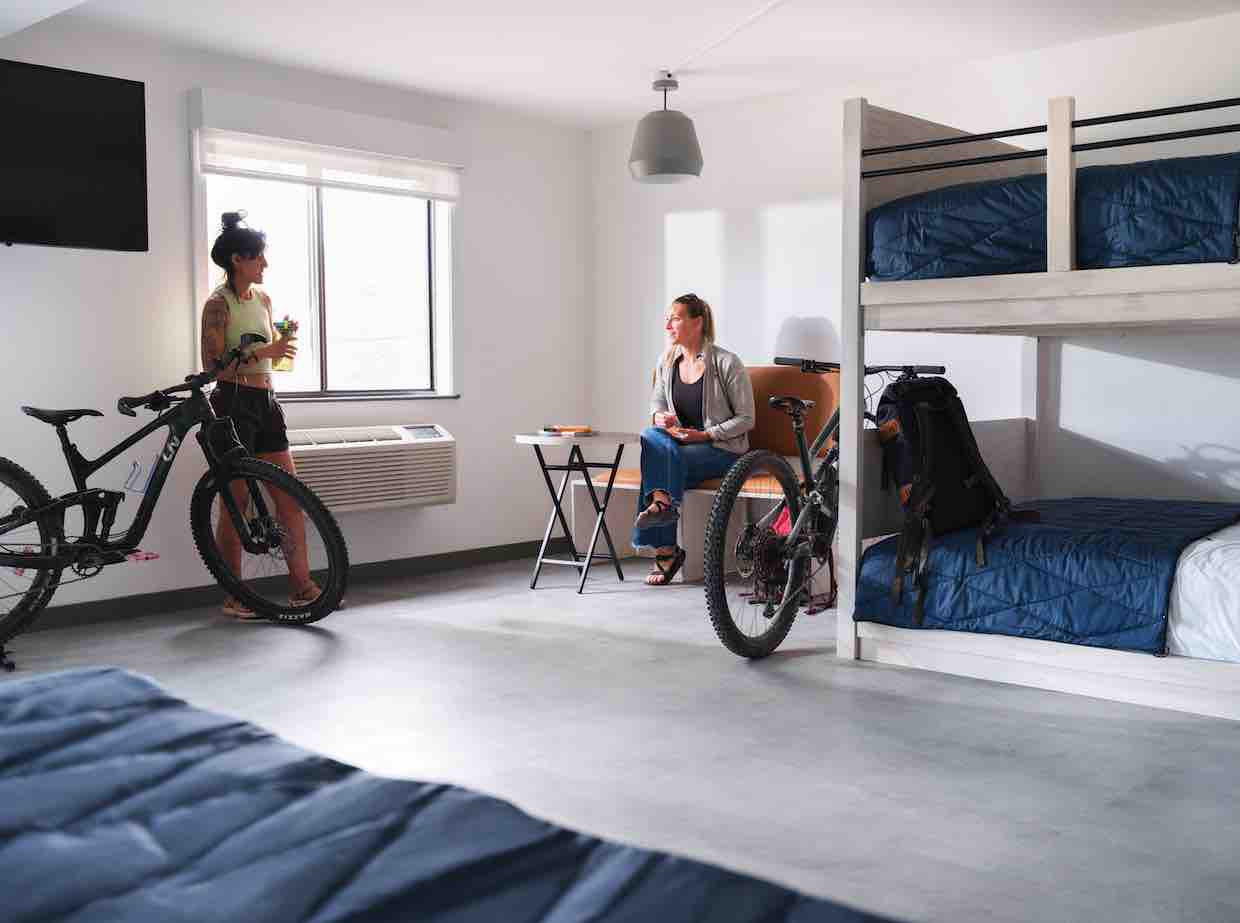 Two women chatting in a room with bunk beds